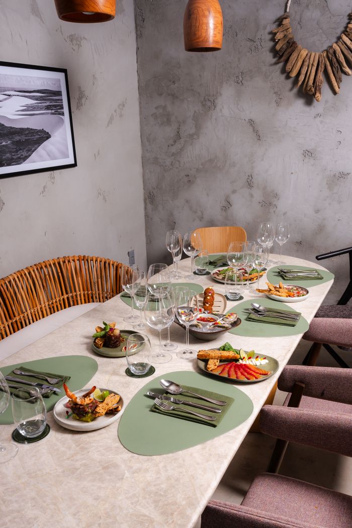 A sophisticated dining setup with colorful appetizers, elegant cutlery, and decorative elements.